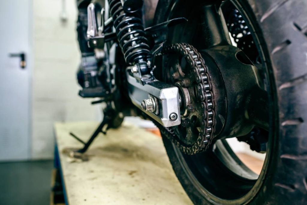 Detail of wheel of customized motorcycle parked in the workshop