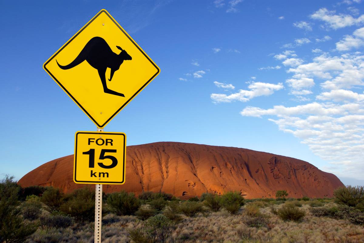 Road sign near Ayers Rock in the Northern Territory of Australia. It is the largest monolith in the world, at 348 m high and about 9 km in circumference. Aboriginal name Uluru. It is a UNESCO World Heritage Site.